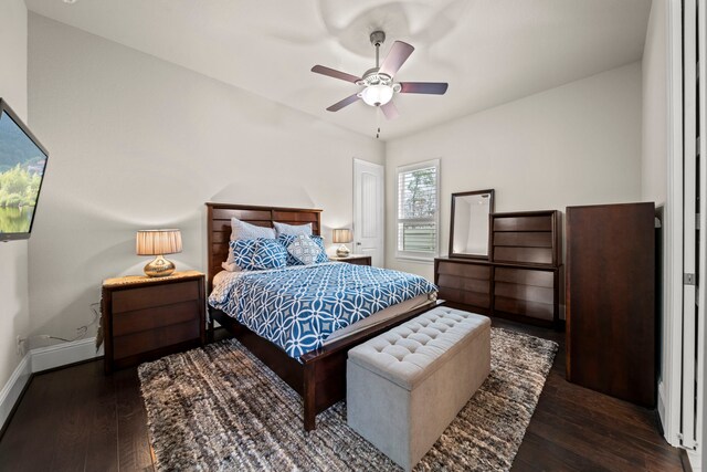 bedroom with dark hardwood / wood-style flooring and ceiling fan