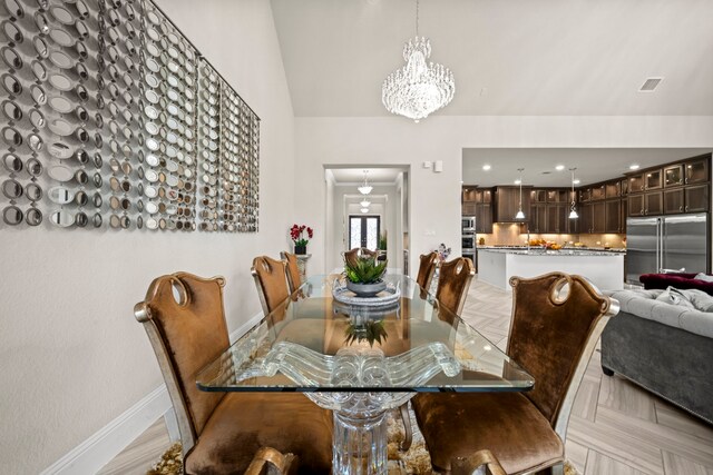 dining area featuring light parquet flooring and a chandelier