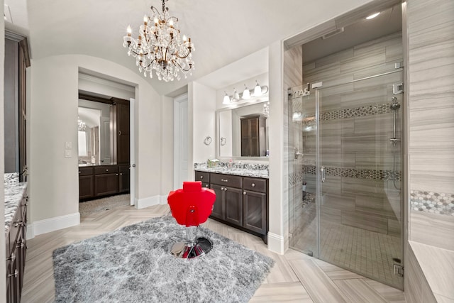 bathroom featuring vanity, an enclosed shower, and lofted ceiling