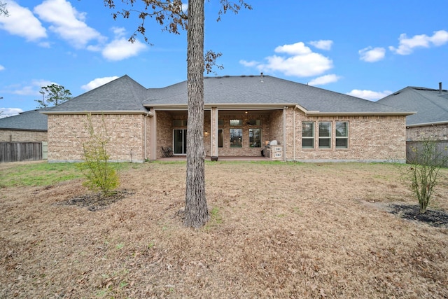 rear view of property with a yard