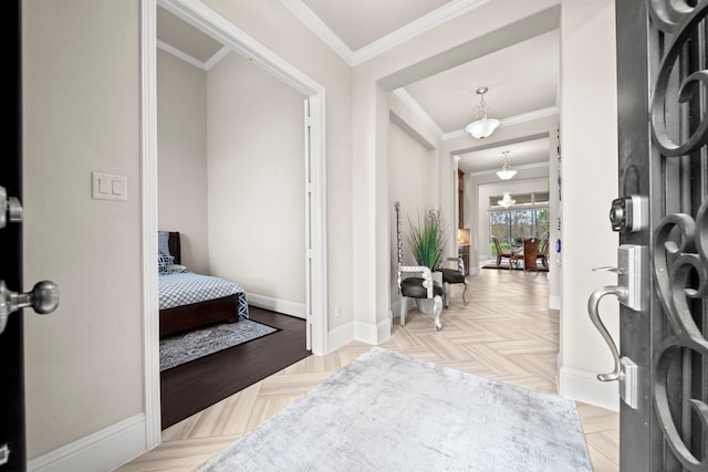 foyer entrance with crown molding and light parquet flooring