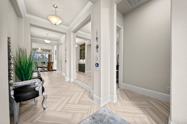 entryway with crown molding and light parquet flooring