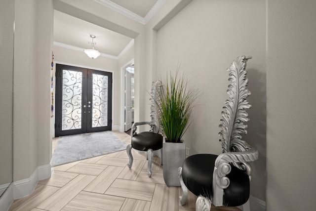 foyer with ornamental molding and french doors