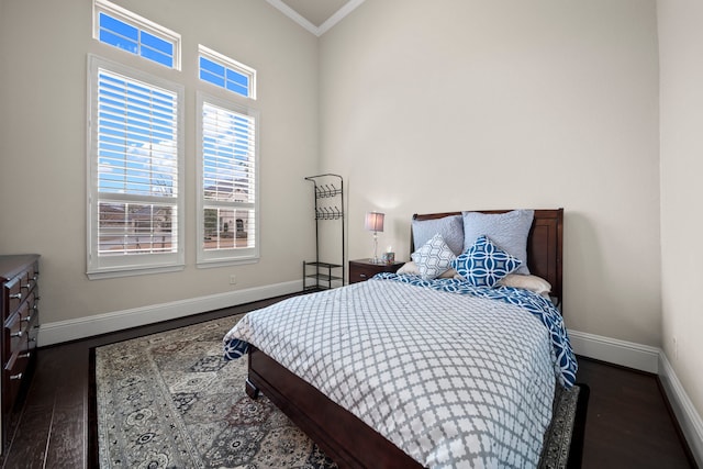 bedroom with ornamental molding and dark hardwood / wood-style floors