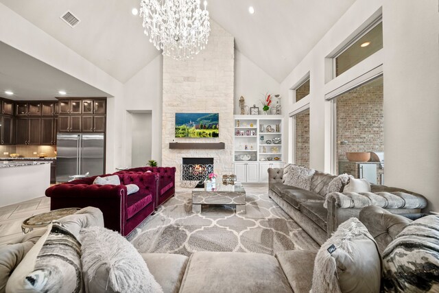 living room featuring a fireplace, high vaulted ceiling, and a chandelier