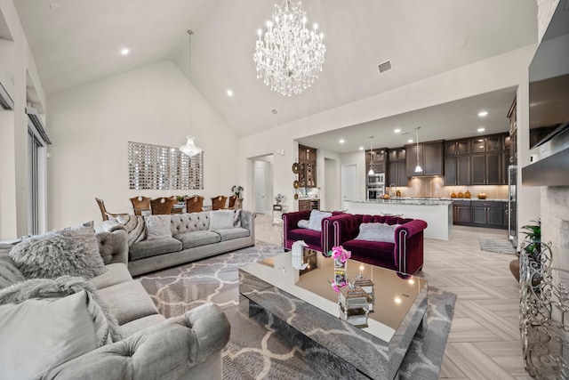 living room featuring light parquet floors, high vaulted ceiling, and a chandelier