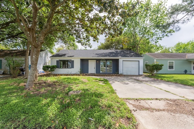 ranch-style home featuring a garage and a front yard