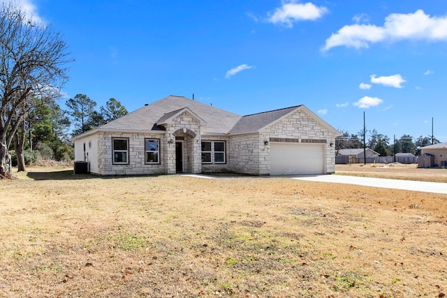 view of front of property featuring a garage and a front lawn