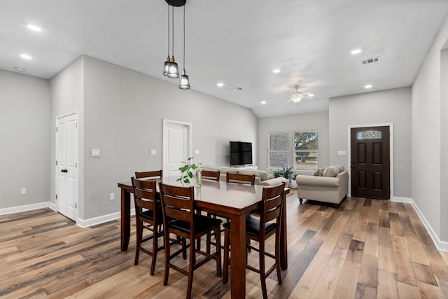 dining area with ceiling fan and light hardwood / wood-style flooring