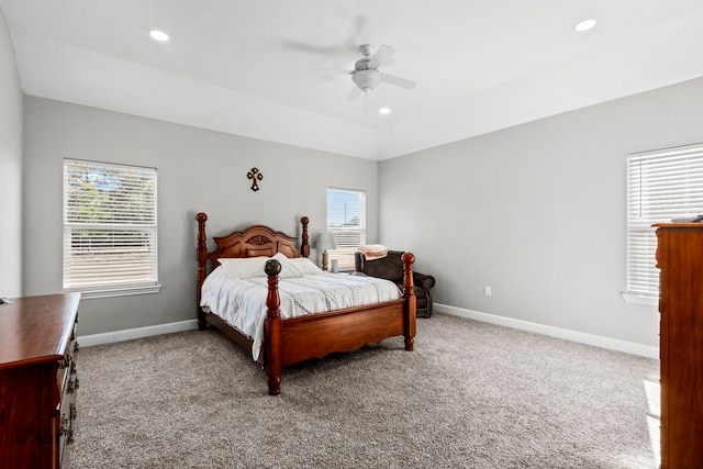 carpeted bedroom featuring multiple windows, lofted ceiling, and ceiling fan