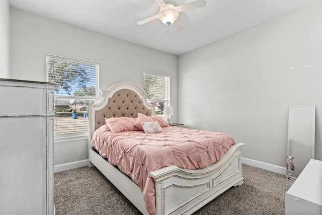 carpeted bedroom with ceiling fan and baseboards