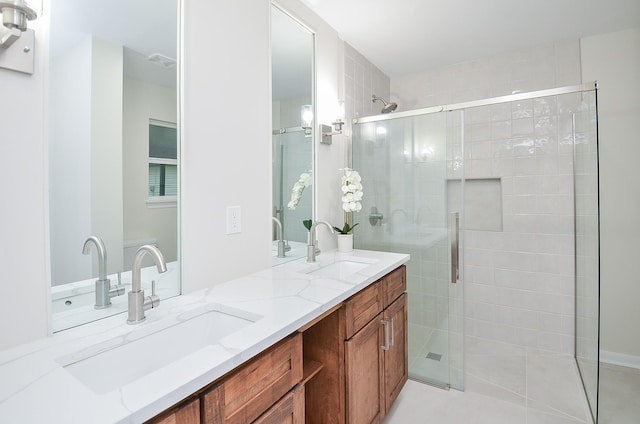 bathroom featuring vanity and an enclosed shower