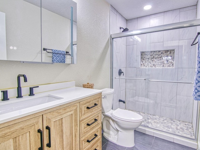 bathroom featuring a shower with door, tile patterned flooring, vanity, a textured ceiling, and toilet