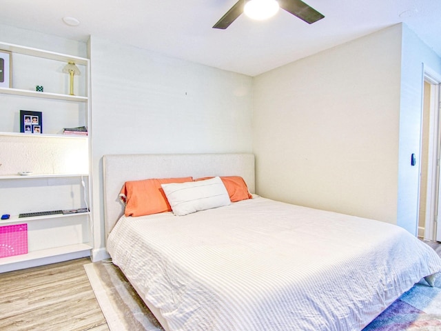 bedroom with hardwood / wood-style flooring and ceiling fan