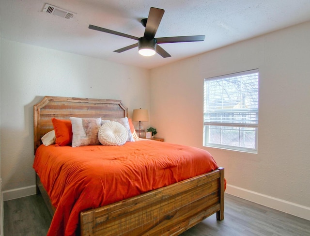 bedroom with ceiling fan and hardwood / wood-style floors