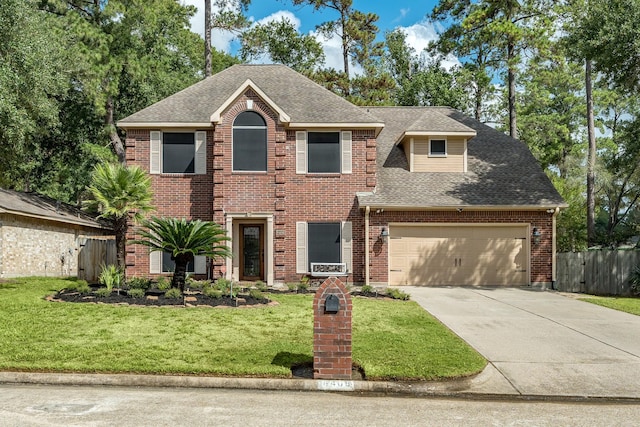 view of front of house with a garage and a front lawn