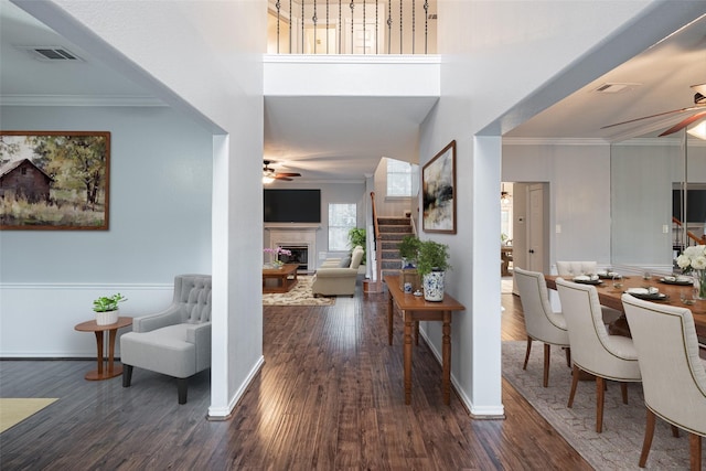 entryway featuring dark hardwood / wood-style flooring, crown molding, and ceiling fan