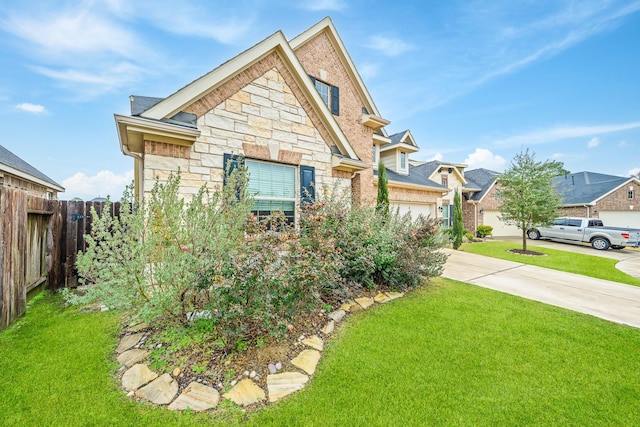 view of front of home with a garage and a front lawn