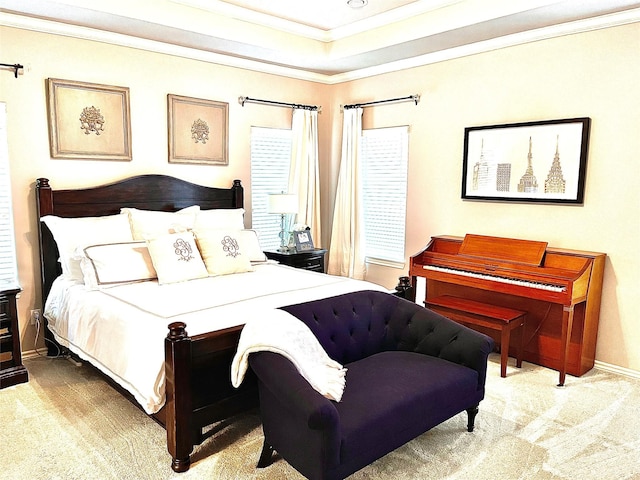 carpeted bedroom with ornamental molding and a raised ceiling