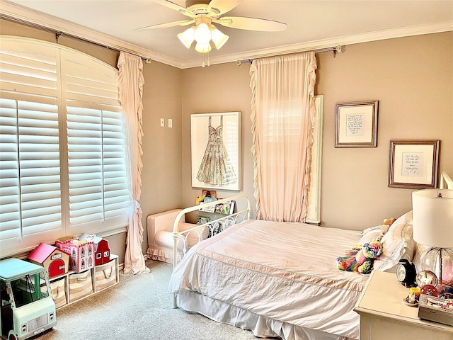 carpeted bedroom with ornamental molding and ceiling fan