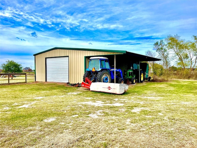 view of outdoor structure with a garage and a lawn