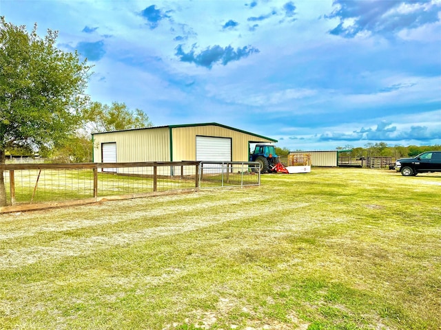 exterior space with a garage and an outbuilding