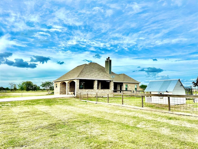 rear view of property with a lawn