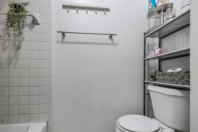 bathroom with a washtub and toilet