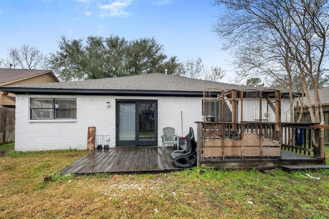 rear view of property with a yard and a deck