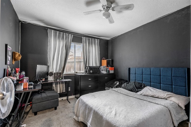 bedroom featuring light colored carpet, a textured ceiling, and ceiling fan