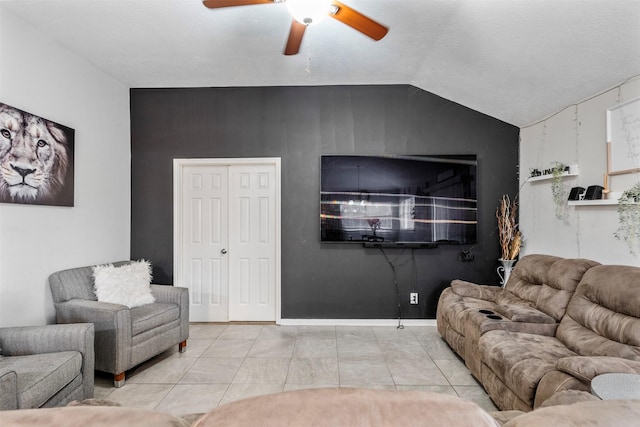 tiled living room featuring lofted ceiling and ceiling fan