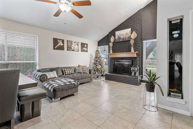 tiled living room featuring a brick fireplace, vaulted ceiling, a healthy amount of sunlight, and ceiling fan