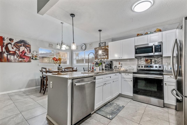 kitchen featuring appliances with stainless steel finishes, sink, decorative backsplash, and white cabinets