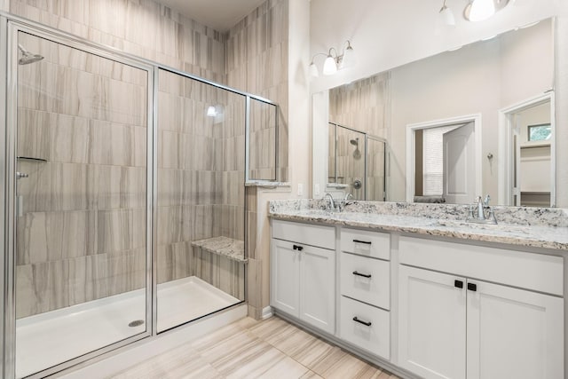 bathroom with vanity and a shower with shower door