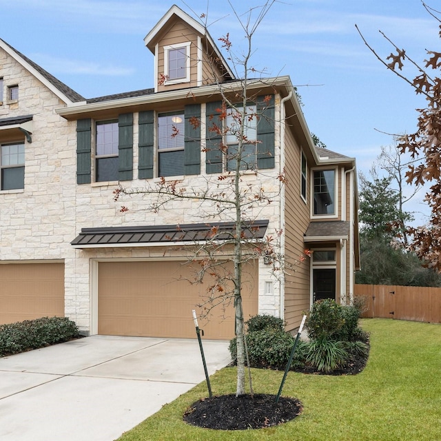 view of front of house featuring a garage and a front yard