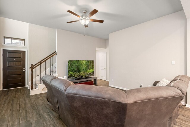 living room with ceiling fan and dark hardwood / wood-style flooring