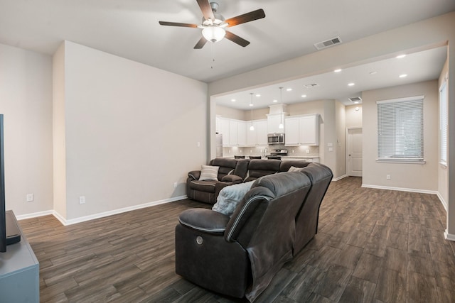 living room with dark hardwood / wood-style floors and ceiling fan