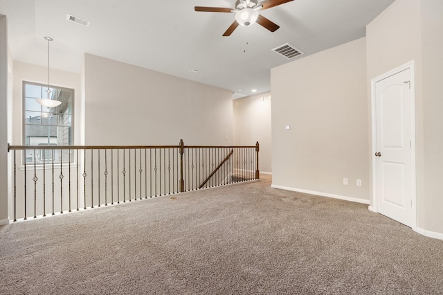 spare room featuring carpet flooring and ceiling fan