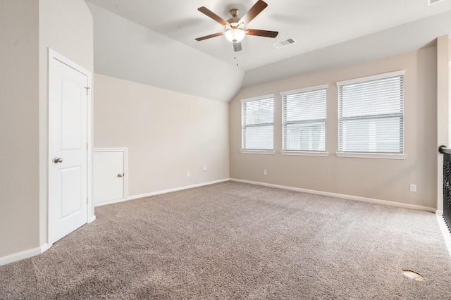 carpeted empty room with lofted ceiling and ceiling fan