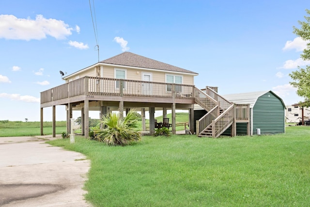 back of property with a carport, a wooden deck, and a yard