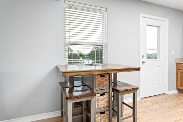 dining space featuring plenty of natural light and light hardwood / wood-style flooring