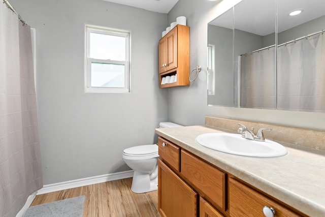 bathroom with vanity, wood-type flooring, and toilet