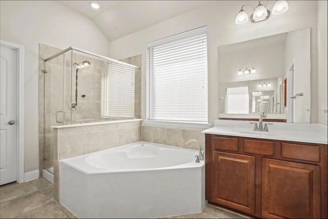 bathroom with lofted ceiling, vanity, plenty of natural light, and independent shower and bath