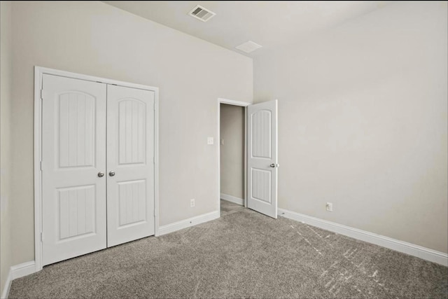 unfurnished bedroom featuring carpet floors and a closet