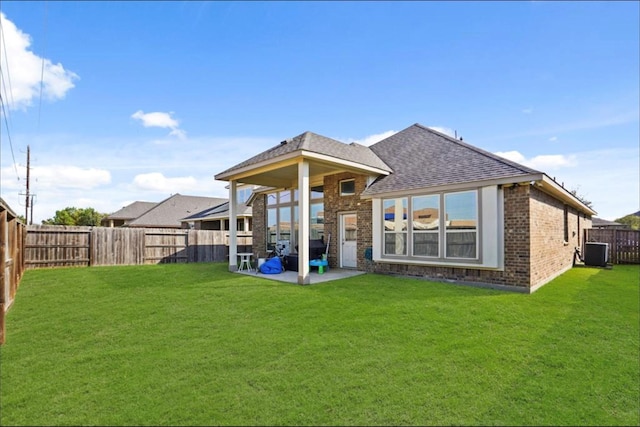 back of house with a patio area, central air condition unit, and a lawn