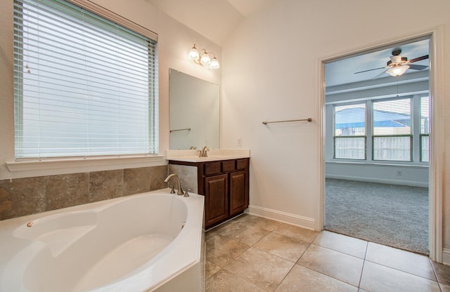 full bath featuring vanity, baseboards, ceiling fan, tile patterned floors, and a bath