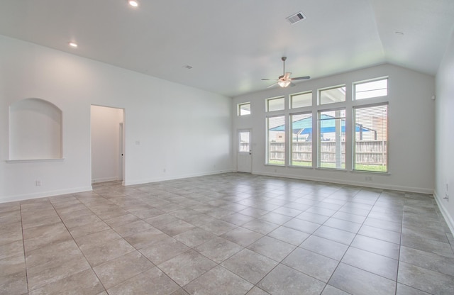 unfurnished living room featuring ceiling fan, baseboards, light tile patterned floors, vaulted ceiling, and visible vents