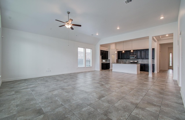 unfurnished living room with a ceiling fan, a sink, baseboards, lofted ceiling, and recessed lighting