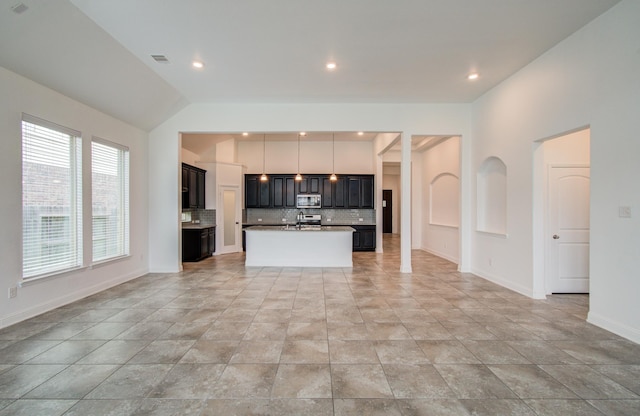 unfurnished living room featuring a healthy amount of sunlight, baseboards, recessed lighting, and visible vents