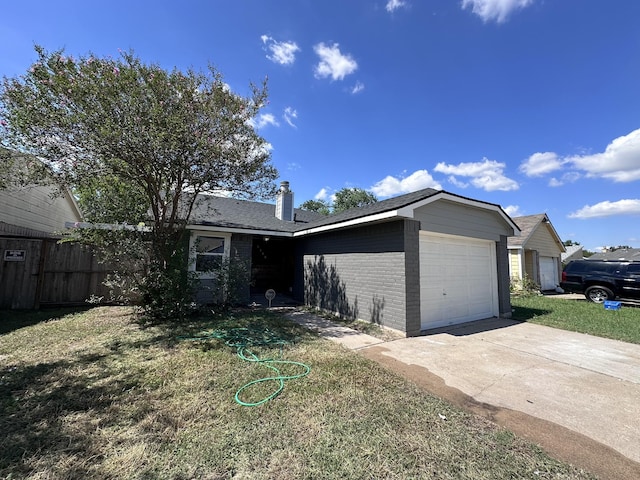 view of front facade with an attached garage, driveway, a front lawn, and brick siding